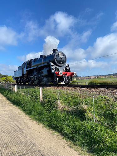 The North Norfolk railway heading alongside Sheringham golf course