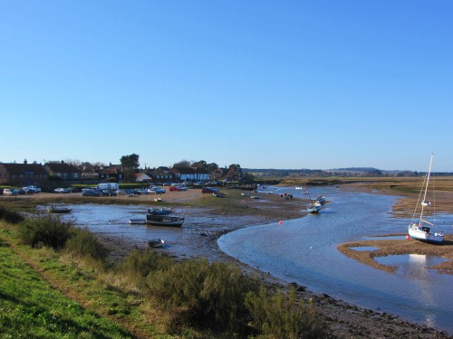 Looking back at Burnham Overy Staithe as you walk along the Norfolk Coast Path Looking back at Burnham Overy Staithe as you walk along the Norfolk Coast Path