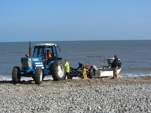 The fishermen coming onto Cromer beach