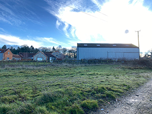 Walk around to the right of this farm building