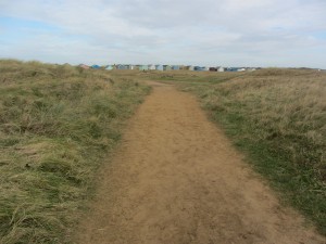 Walking through the golf course to the beach huts