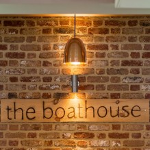 The Boathouse sign on the brick wall The Boathouse sign on the brick wall