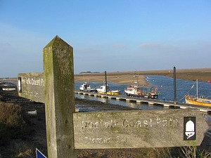 Norfolk Coast Path goes along the sea wall at Wells next the Sea Norfolk