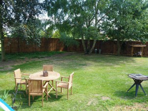 Tables, chairs, firepit and BBQ outside The Woodland Boat